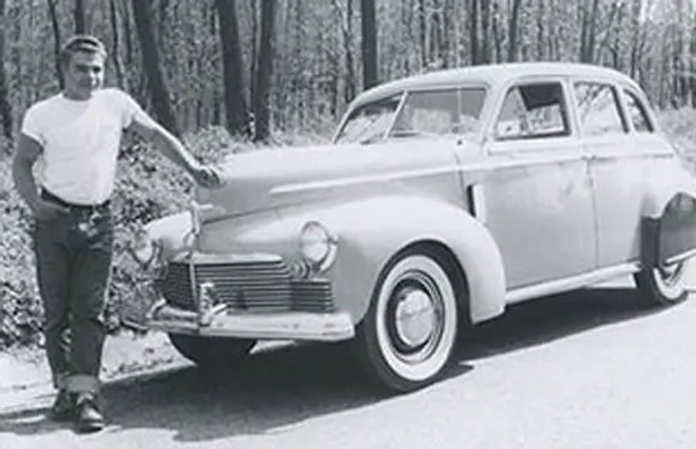 Harold Gross in front of older car, black and white image